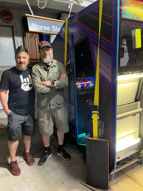 Tim Lapetino, left, and James Zespy by the “Discs of Tron” arcade machine. (Tim Lapetino)